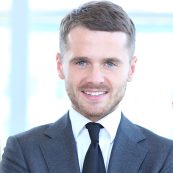 a man in a suit and tie posing for a picture.